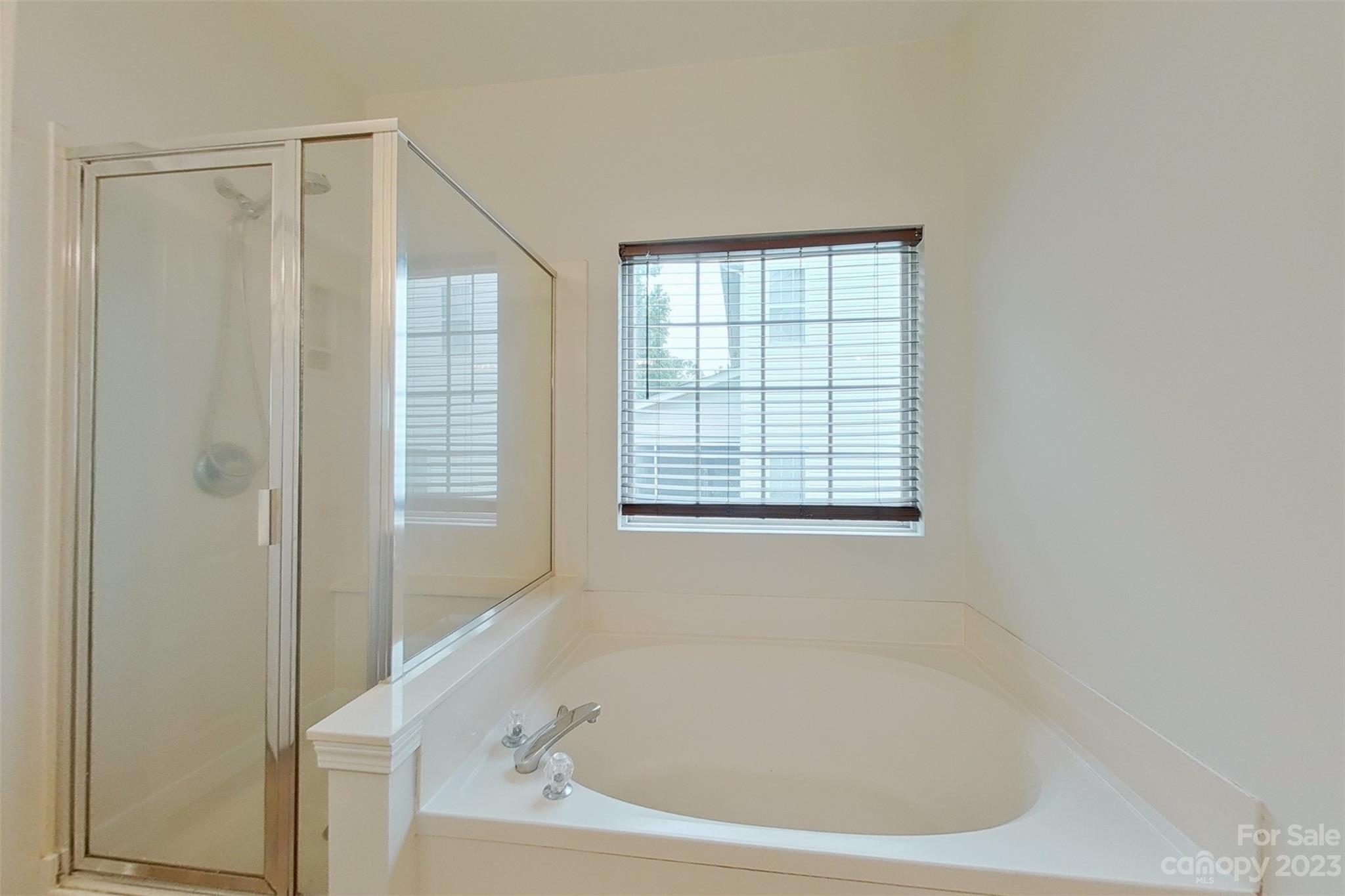 6912 Reedy Creek Road Charlotte, NC 28215 - Photo 19 of 43 a white bath tub sitting next to a window