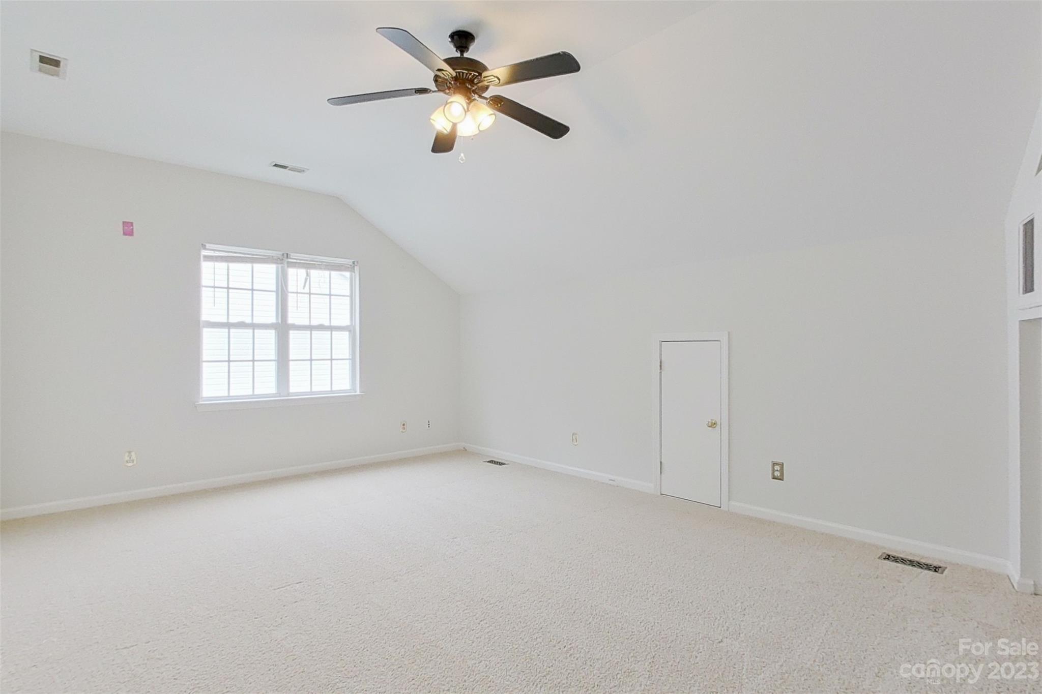 6912 Reedy Creek Road Charlotte, NC 28215 - Photo 31 of 43 an empty room with windows and fan