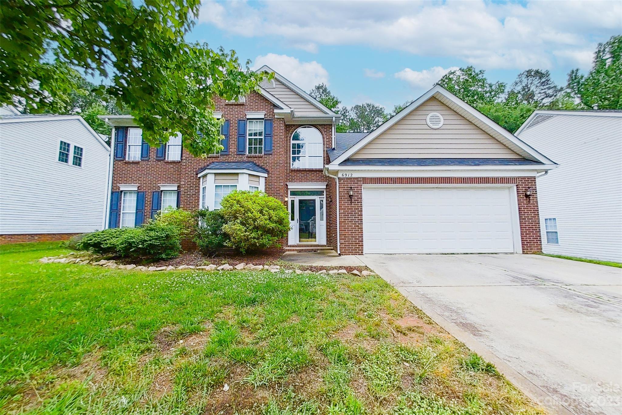 6912 Reedy Creek Road Charlotte, NC 28215 - Photo 4 of 43 front view of a house and a yard