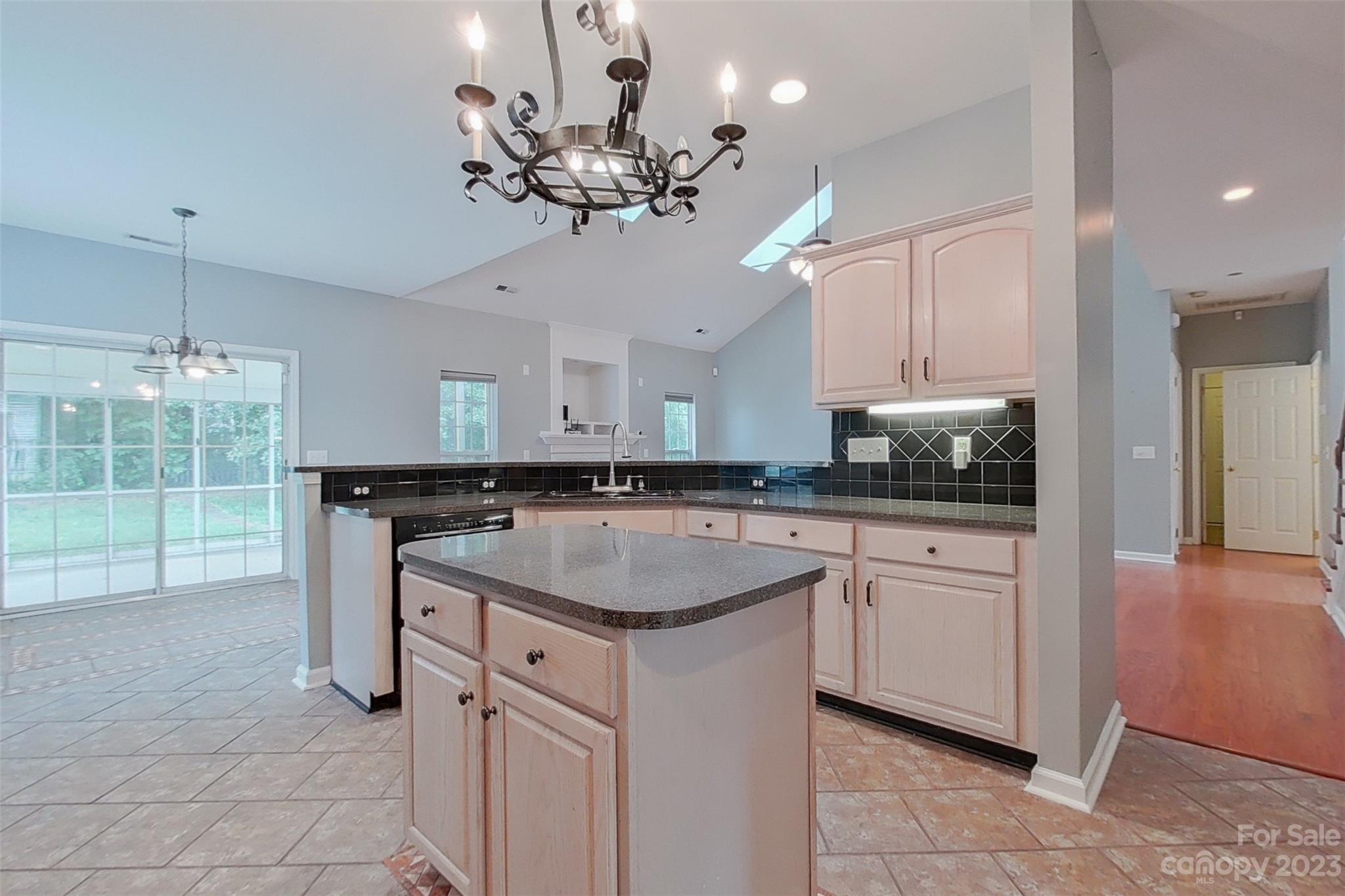 6912 Reedy Creek Road Charlotte, NC 28215 - Photo 9 of 43 a kitchen with a sink and chandelier