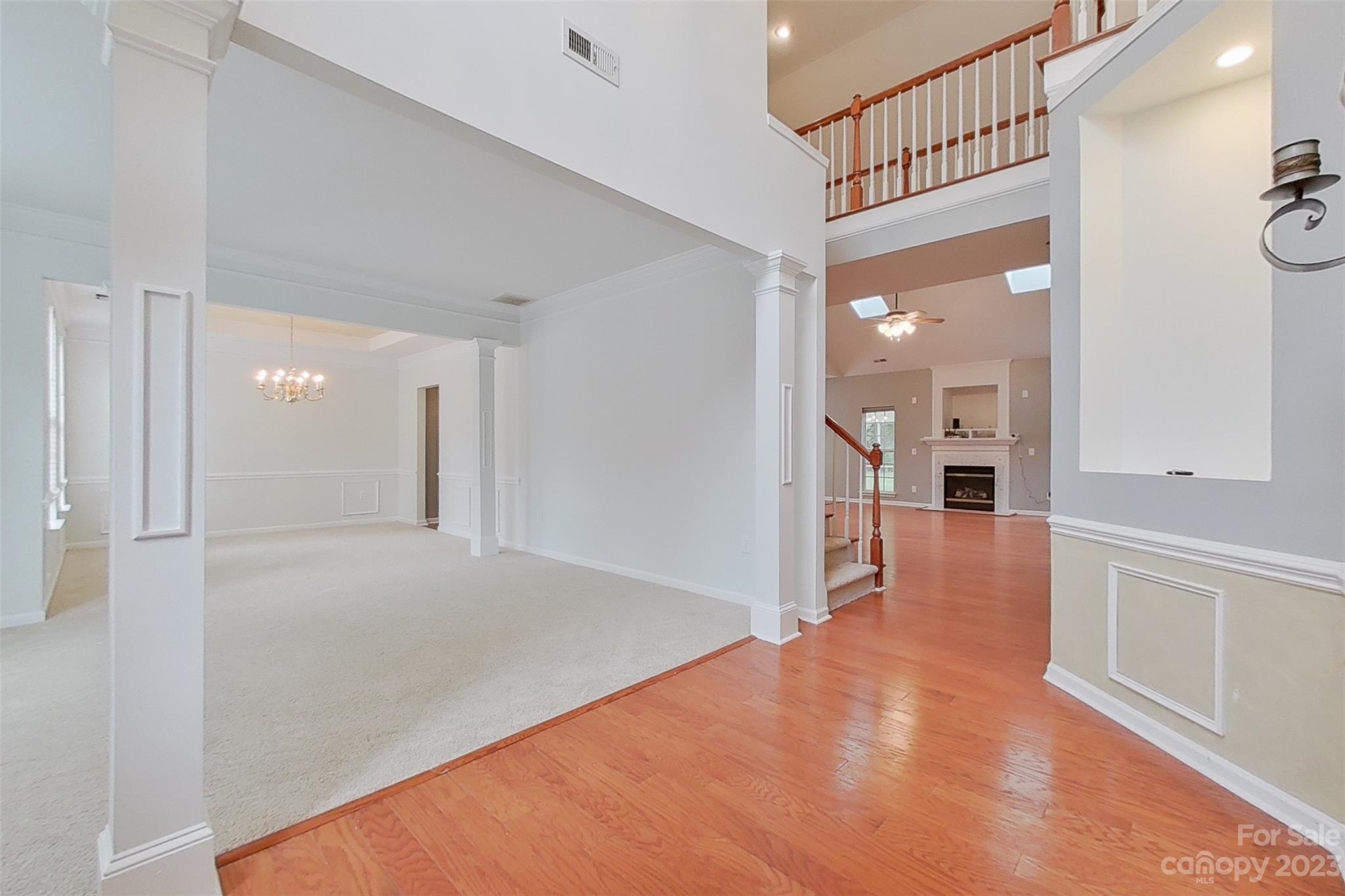 6912 Reedy Creek Road Charlotte, NC 28215 - Photo 10 of 43 a view of a hallway with wooden floor and a living room