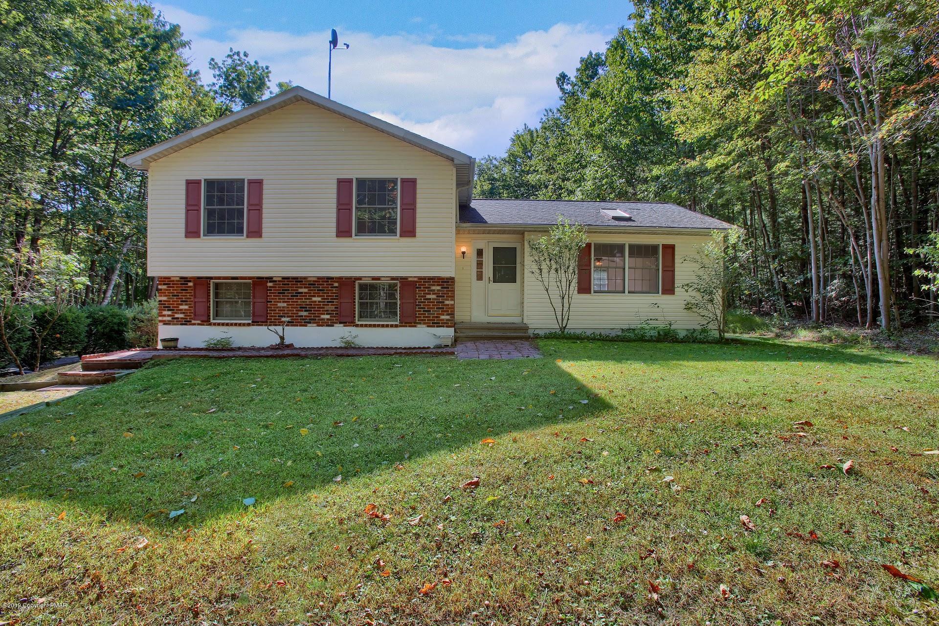 295 Sundance Road Effort, PA 18330 - Photo 1 of 25 a front view of a house with a yard and trees