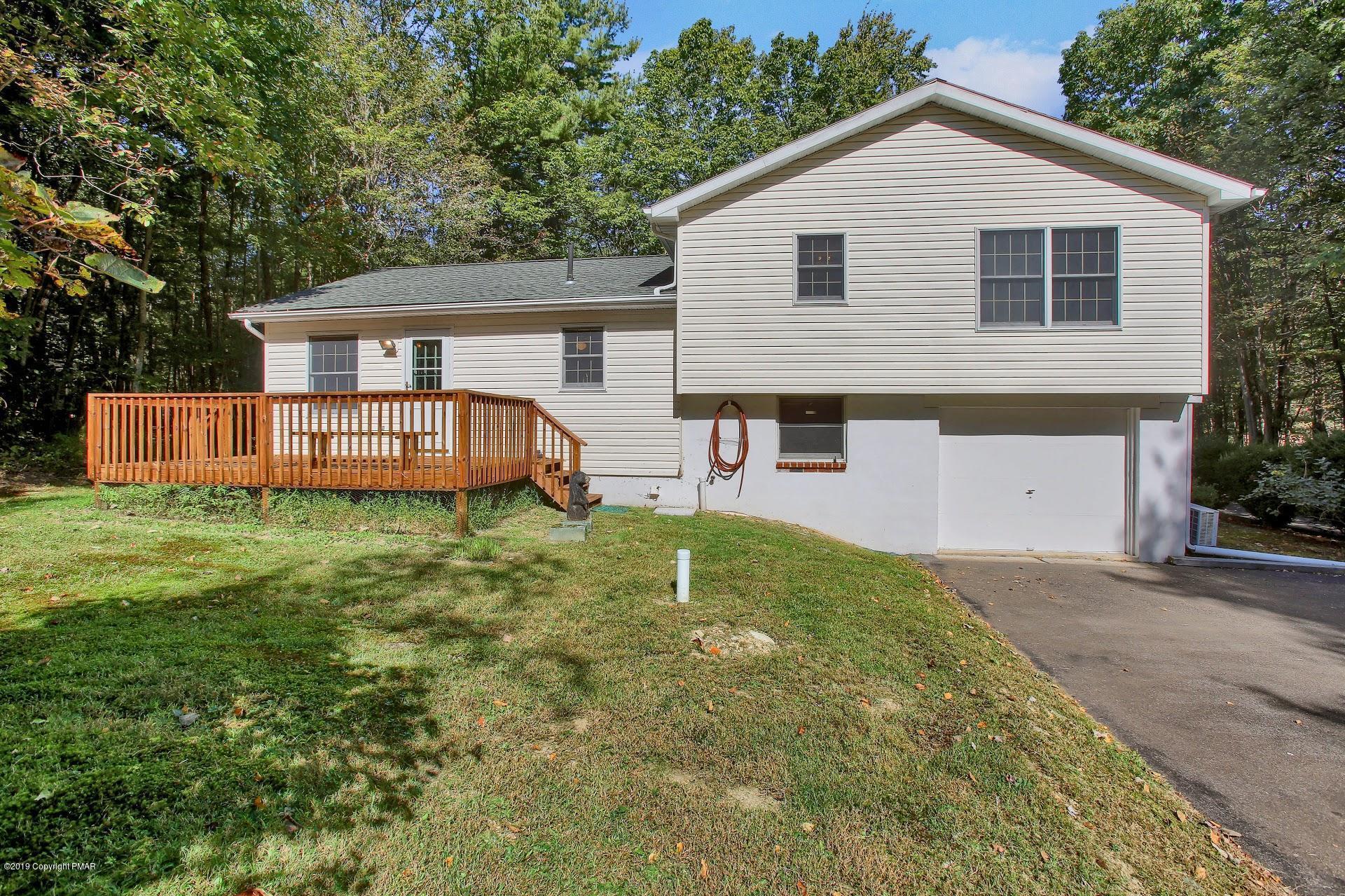 295 Sundance Road Effort, PA 18330 - Photo 21 of 25 a front view of a house with a yard and garage