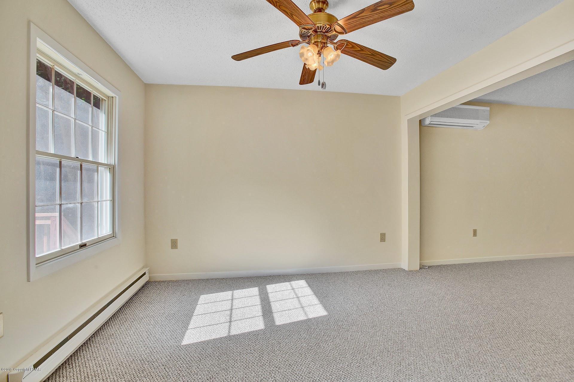 295 Sundance Road Effort, PA 18330 - Photo 5 of 25 an empty room with windows and fan