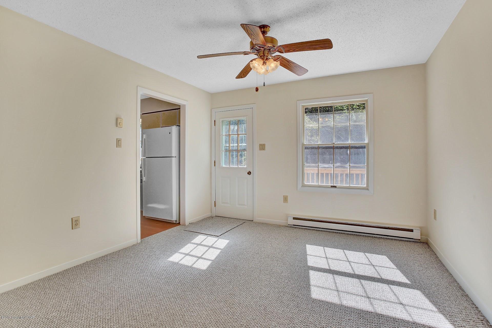 295 Sundance Road Effort, PA 18330 - Photo 6 of 25 an empty room with windows and ceiling fan