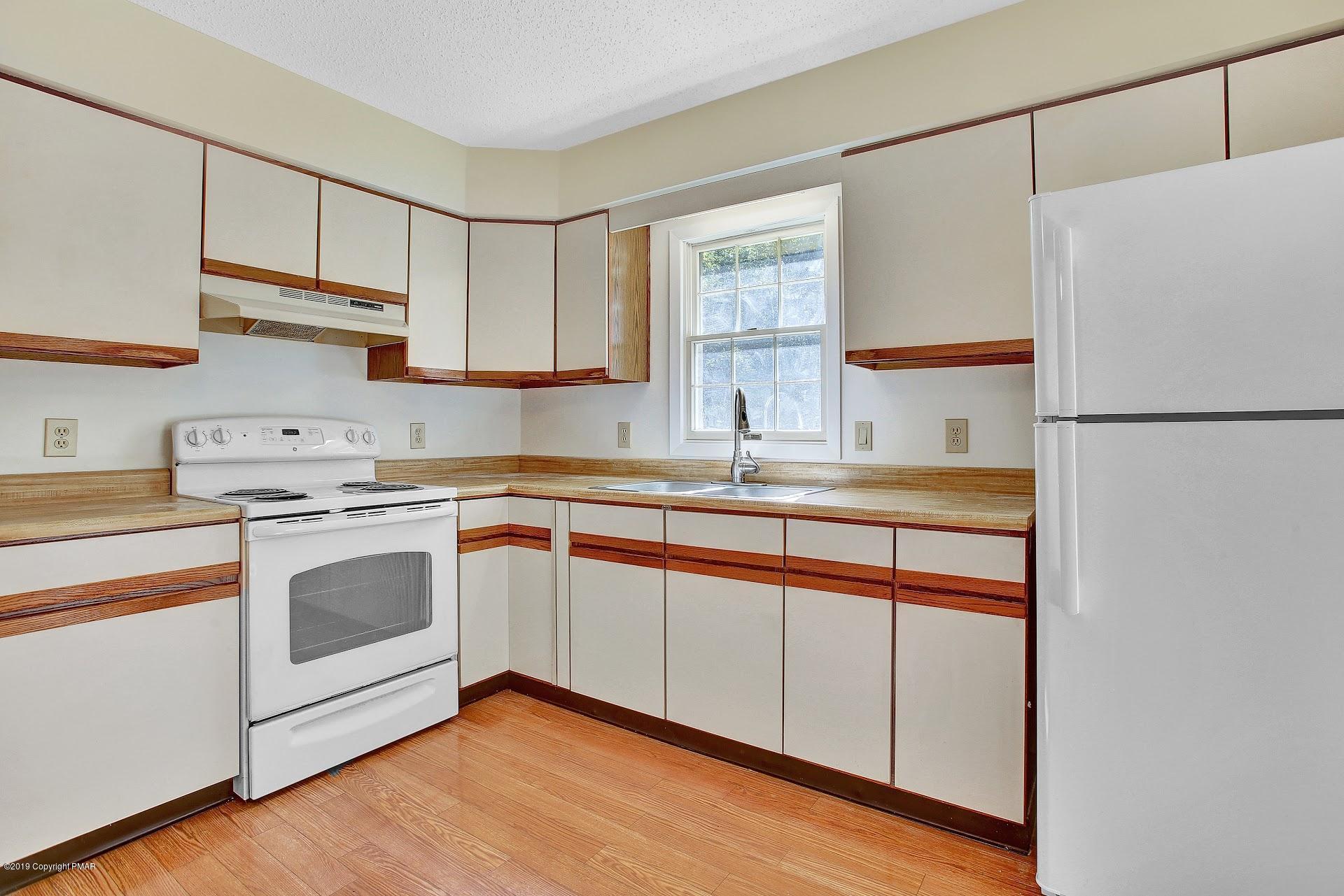 295 Sundance Road Effort, PA 18330 - Photo 7 of 25 a kitchen with stainless steel appliances white cabinets and a sink