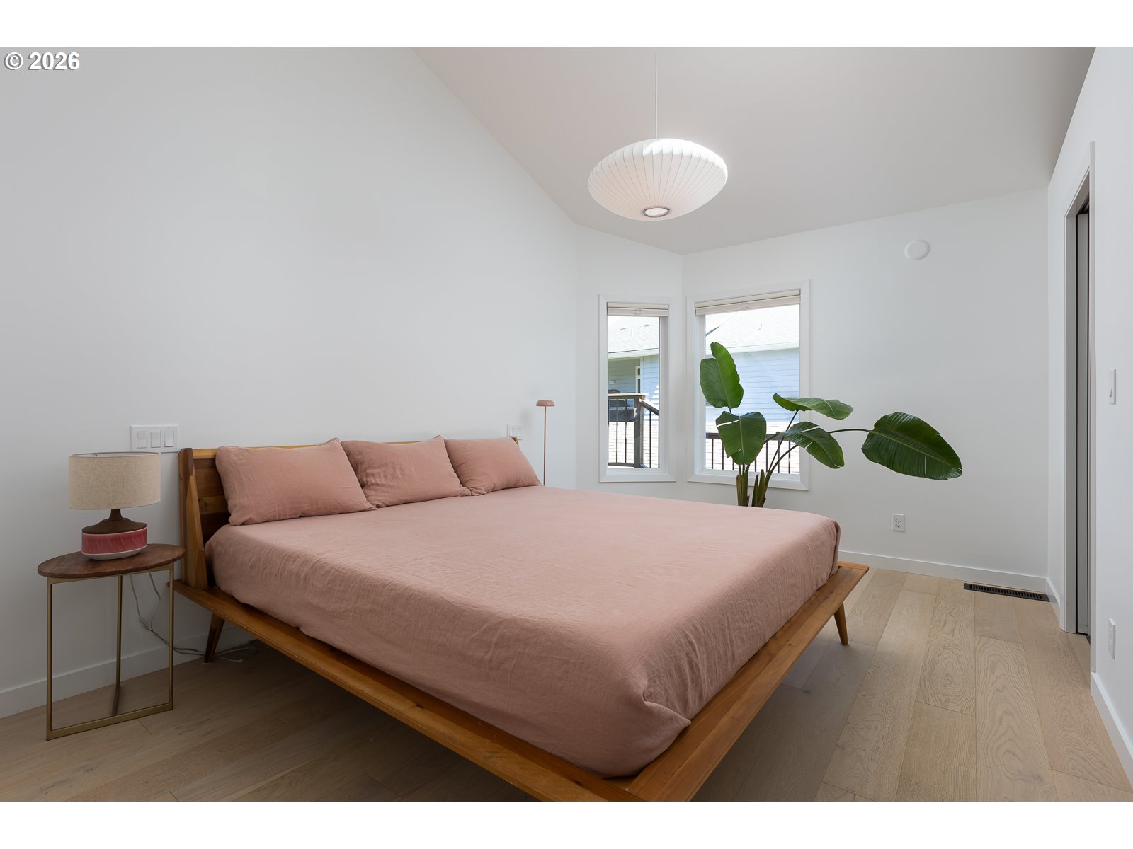 34098 Brooten Road Pacific City, OR 97135 - Photo 15 of 38 a bedroom with a bed and a lamp