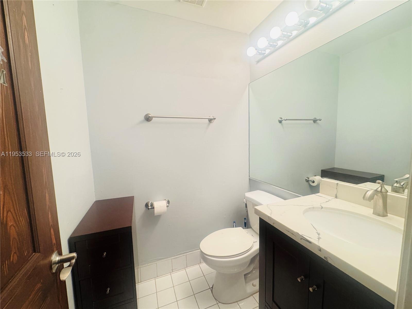11510 Southwest 191st Terrace Miami, FL 33157 - Photo 11 of 15 a bathroom with a granite countertop toilet and sink