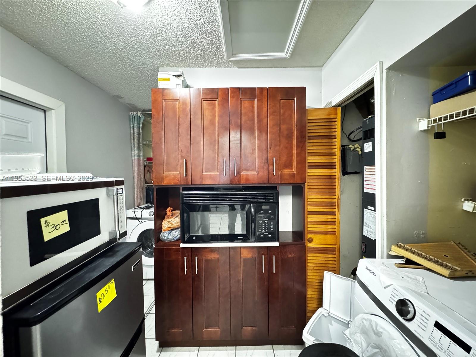 11510 Southwest 191st Terrace Miami, FL 33157 - Photo 12 of 15 a kitchen with a stove and a microwave