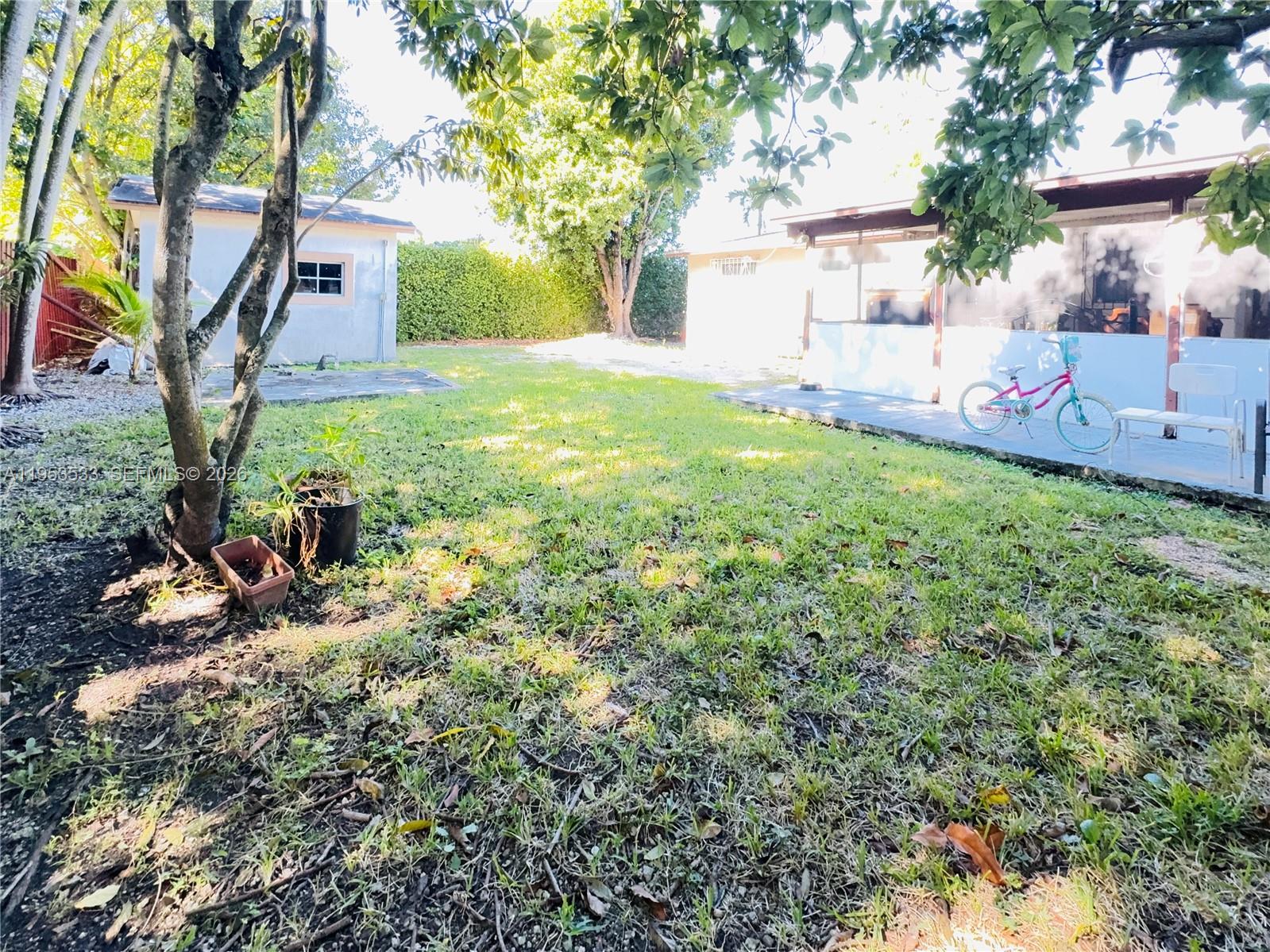 11510 Southwest 191st Terrace Miami, FL 33157 - Photo 13 of 15 a view of a house with backyard and a tree