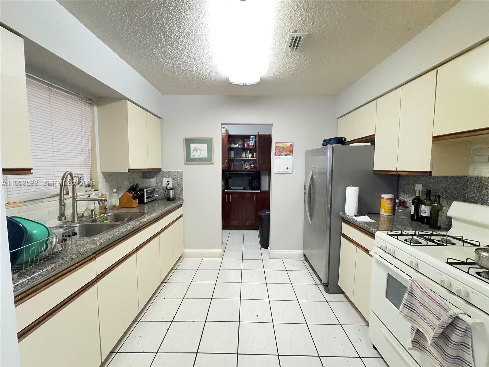 11510 Southwest 191st Terrace Miami, FL 33157 - Photo 5 of 15 a kitchen with stainless steel appliances a refrigerator sink and cabinets