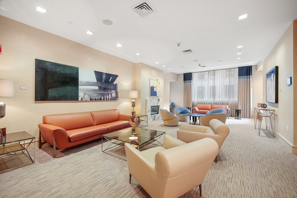 45 Province Street, Unit 1903 Boston, MA 02108 - Photo 19 of 31 a living room with furniture and a flat screen tv