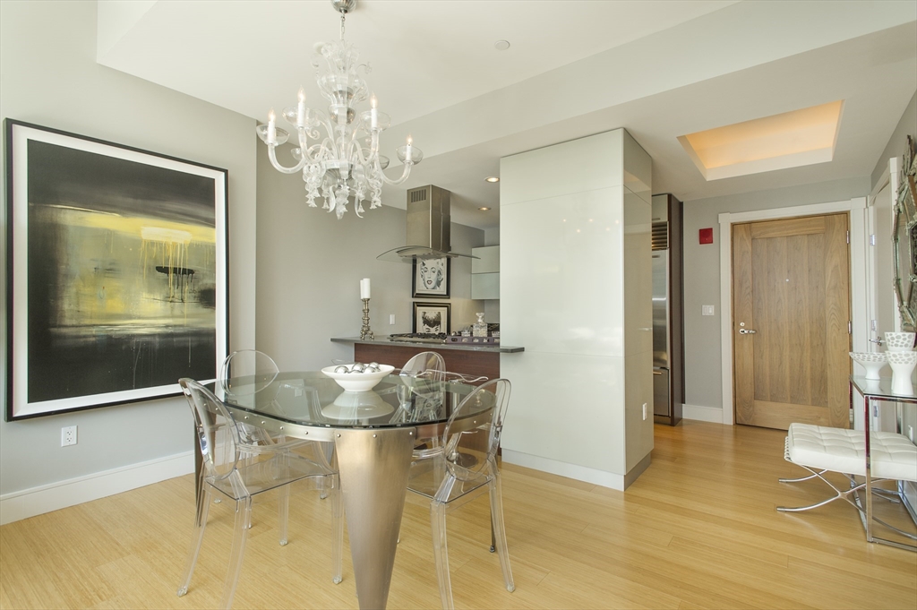 45 Province Street, Unit 1903 Boston, MA 02108 - Photo 3 of 31 a dining room with chandelier and glass door