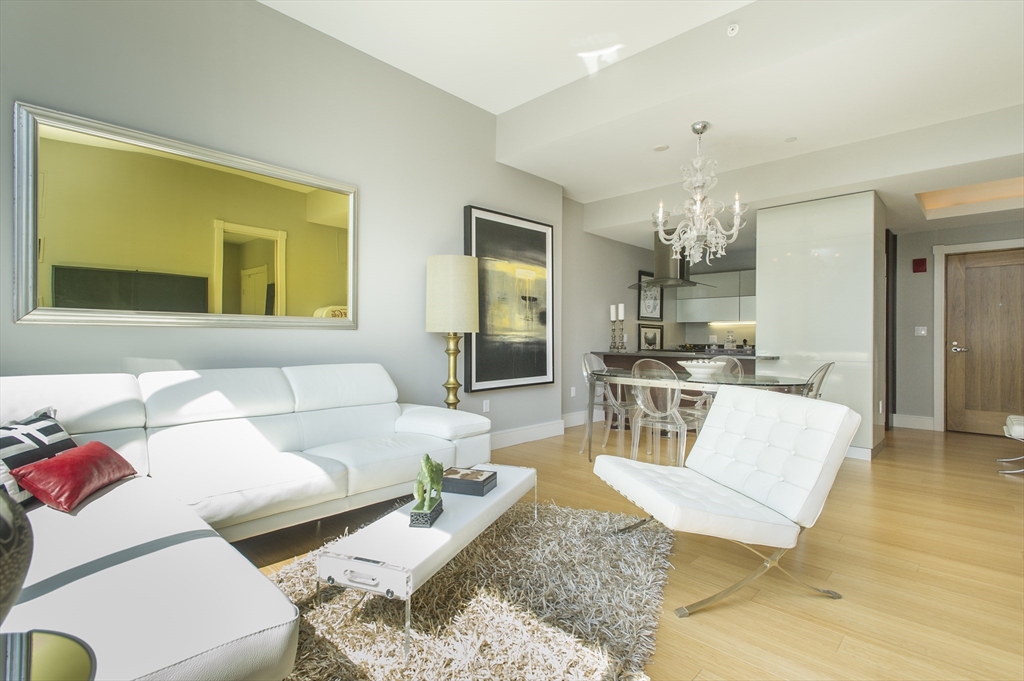 45 Province Street, Unit 1903 Boston, MA 02108 - Photo 4 of 31 a living room with furniture and a chandelier