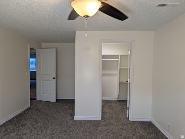 171 South Mustang Road East Grantsville, UT 84029 - Photo 23 of 41 Interior room featuring neutral wall paint, gray carpet flooring, white baseboards, and a ceiling fan with integrated lighting