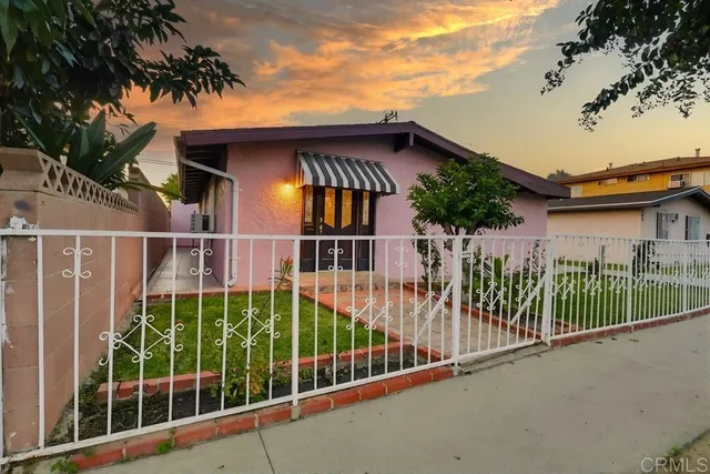 a view of a house with a small yard and plants