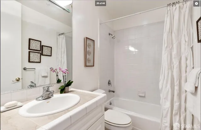 a view of a hallway to a livingroom with furniture