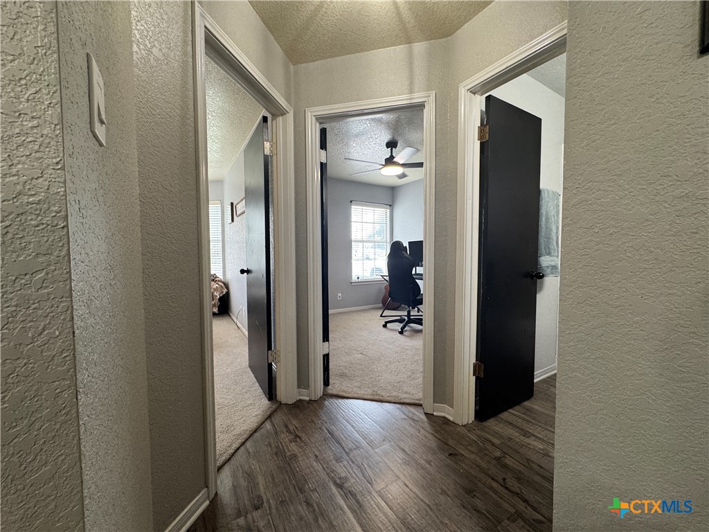 1817 Dusk Drive Killeen, TX 76543 - Photo 13 of 23 a view of a hallway with wooden floor and a bathroom
