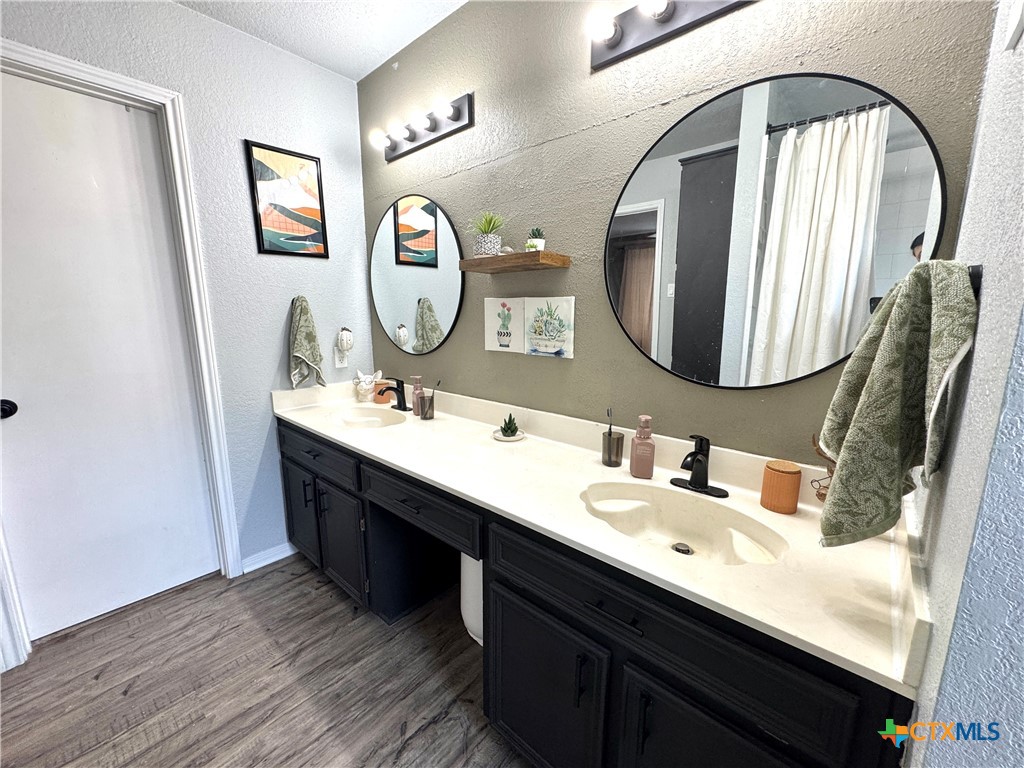 1817 Dusk Drive Killeen, TX 76543 - Photo 21 of 23 a bathroom with a double vanity sink and a mirror