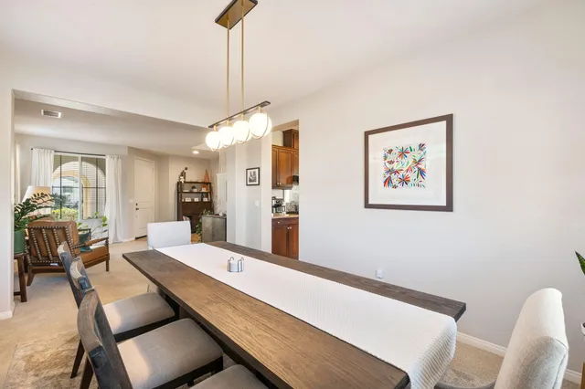 a living room with furniture fireplace and a large window