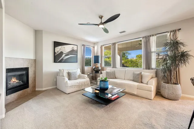 a bedroom with a balcony a bed and a chandelier