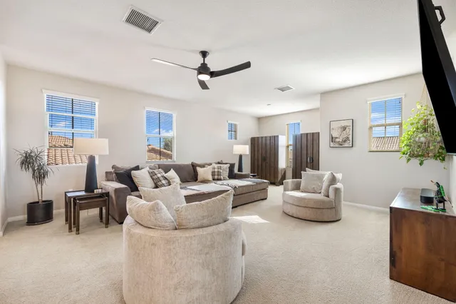 a bedroom with a bed and a potted plant