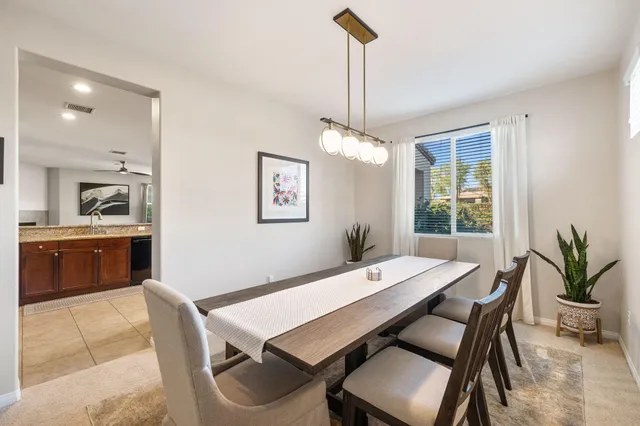 a kitchen with stainless steel appliances kitchen island granite countertop a stove a sink a refrigerator and cabinets