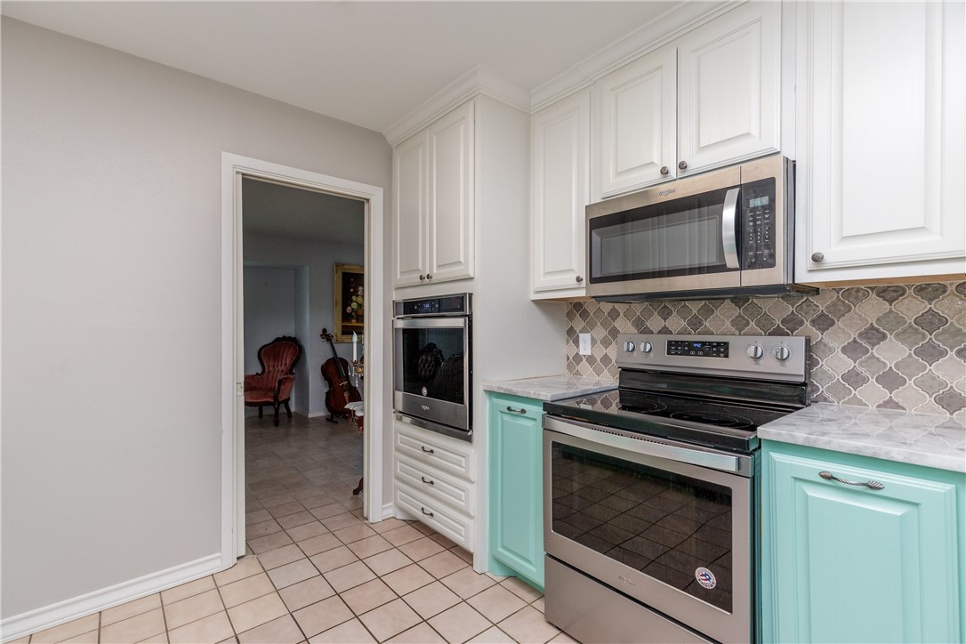 4401 Bluefield Drive Corpus Christi, TX 78413 - Photo 17 of 25 a kitchen with cabinets and steel appliances