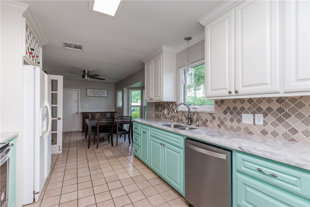 4401 Bluefield Drive Corpus Christi, TX 78413 - Photo 19 of 25 a kitchen with stainless steel appliances granite countertop a sink and cabinets