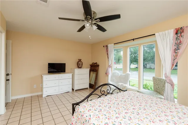 a bedroom with a bed and a large window