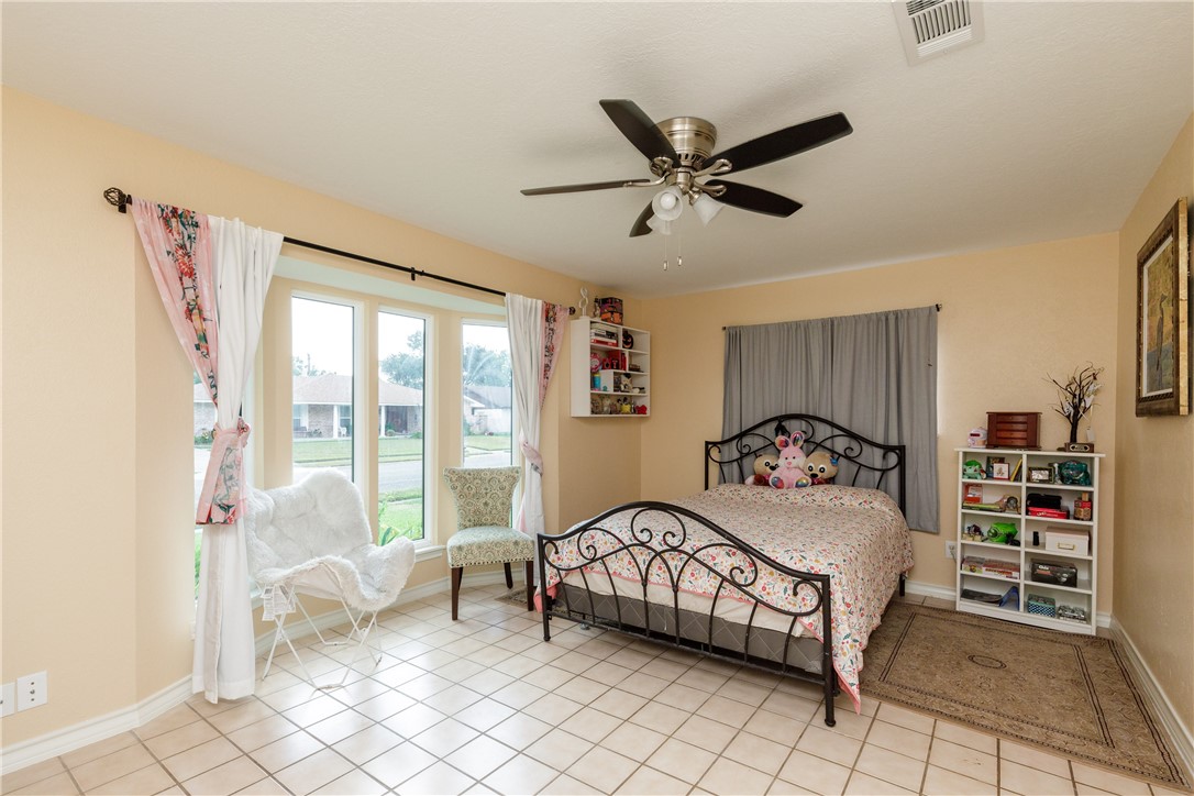 4401 Bluefield Drive Corpus Christi, TX 78413 - Photo 24 of 25 a bedroom with a bed and a large window