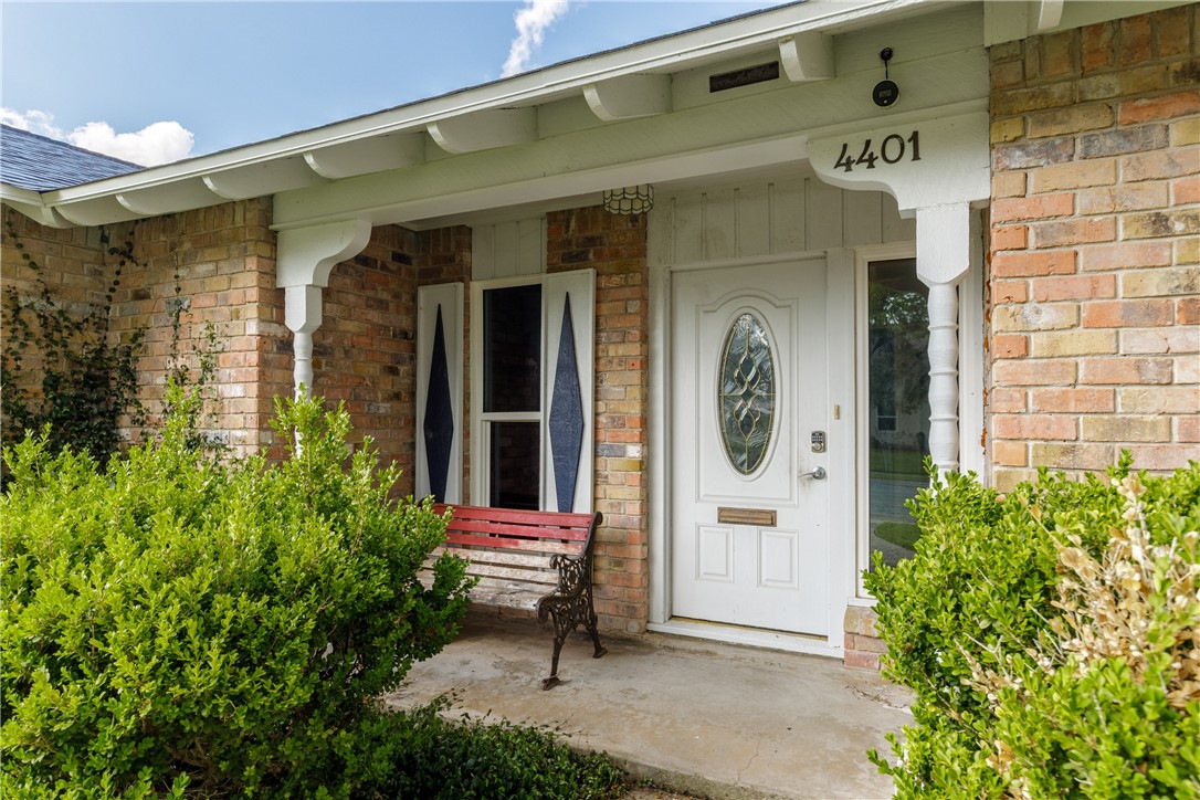 4401 Bluefield Drive Corpus Christi, TX 78413 - Photo 7 of 25 a front view of a house with a garden