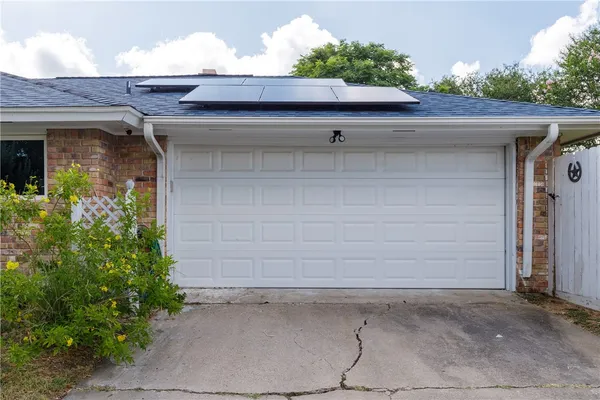 a side view of a house with a garage