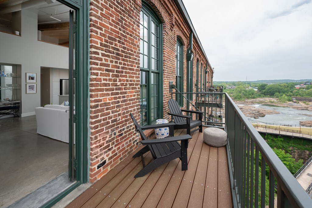 1201 Front Avenue, Unit 507 Columbus, GA 31901 - Photo 11 of 46 a balcony with wooden floor and outdoor seating