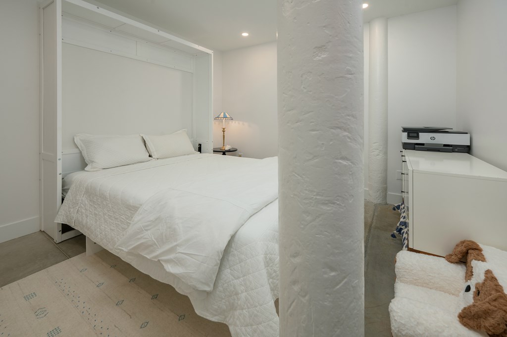 1201 Front Avenue, Unit 507 Columbus, GA 31901 - Photo 22 of 46 a bedroom with a bed and a mirror