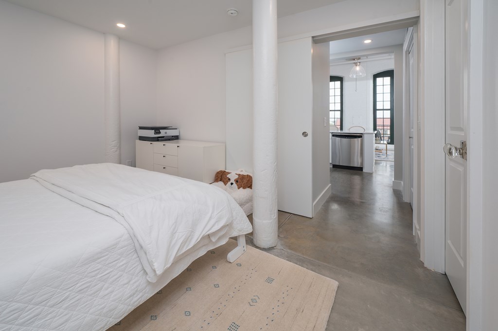 1201 Front Avenue, Unit 507 Columbus, GA 31901 - Photo 24 of 46 a bedroom with a bed and a view of bathroom