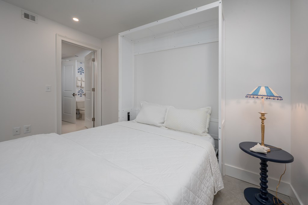 1201 Front Avenue, Unit 507 Columbus, GA 31901 - Photo 25 of 46 a bedroom with a bed and a chandelier