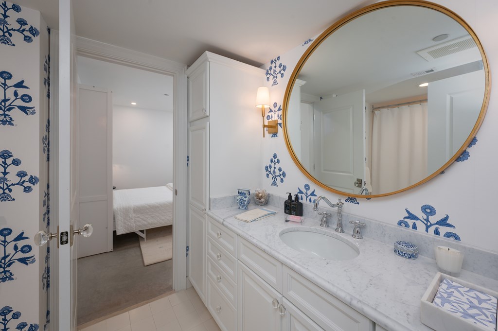 1201 Front Avenue, Unit 507 Columbus, GA 31901 - Photo 29 of 46 a en suite bathroom with a double vanity sink and a mirror