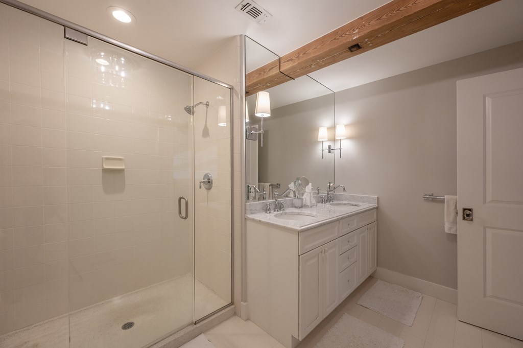 1201 Front Avenue, Unit 507 Columbus, GA 31901 - Photo 42 of 46 a bathroom with a shower sink vanity and mirror
