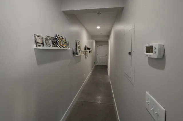a view of a hallway with paintings on the wall