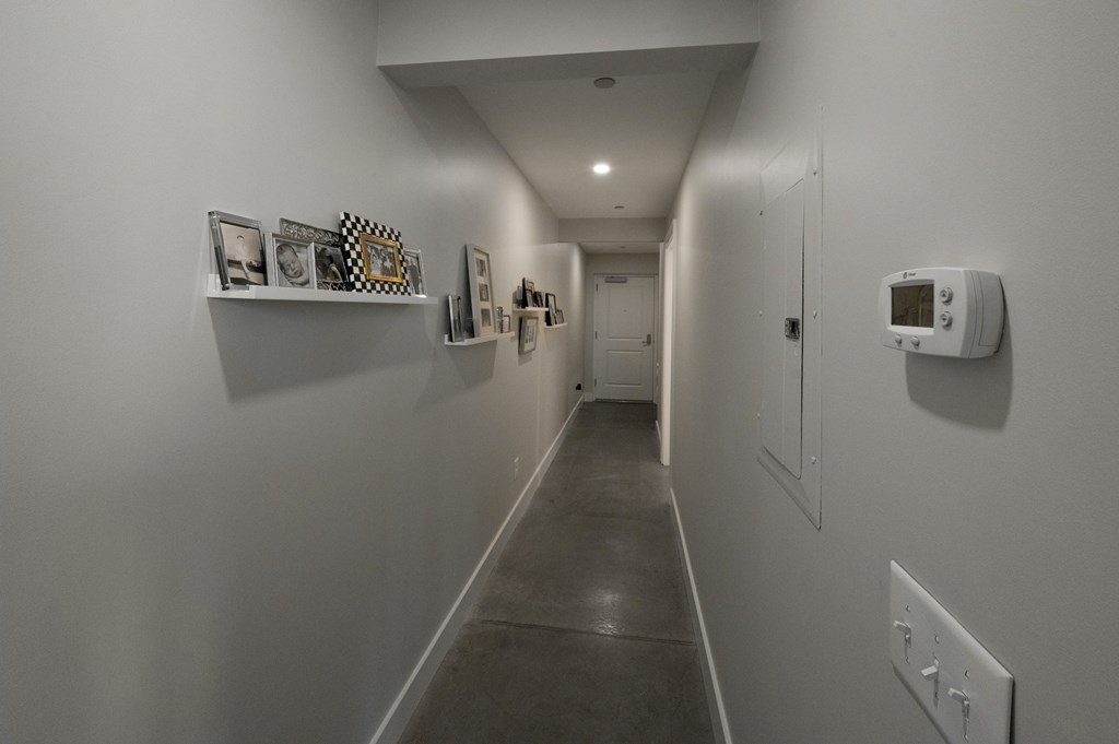 1201 Front Avenue, Unit 507 Columbus, GA 31901 - Photo 5 of 46 a view of a hallway with paintings on the wall