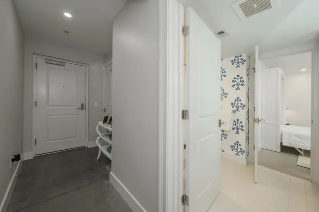 walk in closet with white walls