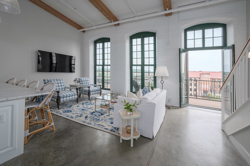 1201 Front Avenue, Unit 507 Columbus, GA 31901 - Photo 7 of 46 a living room with furniture and a flat screen tv