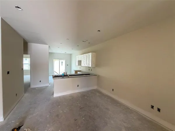 a room with a window and chandelier fan