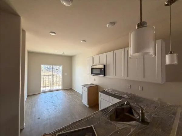 a kitchen with sink cabinets and microwave