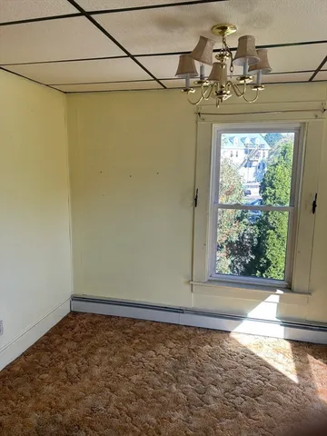 a view of a room with a window and a ceiling fan