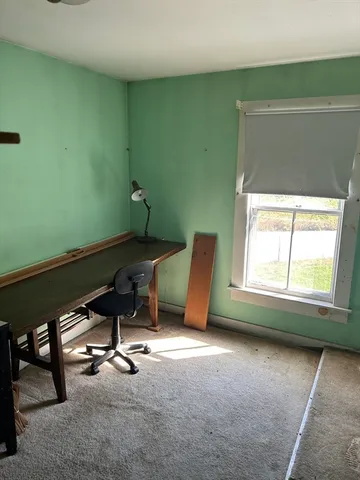 a view of a room with gym equipment and windows