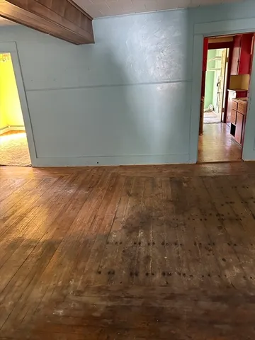 a view of wooden floor and windows in an empty room