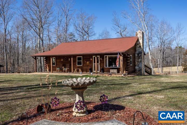 5880 Mechunk Ridge Lane Keswick, VA 22947 - Photo 1 of 38 a front view of a house with garden