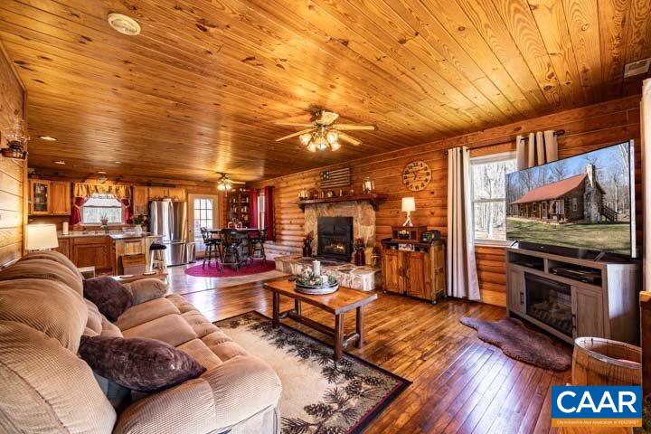 5880 Mechunk Ridge Lane Keswick, VA 22947 - Photo 12 of 38 a living room with lots of furniture and a fireplace
